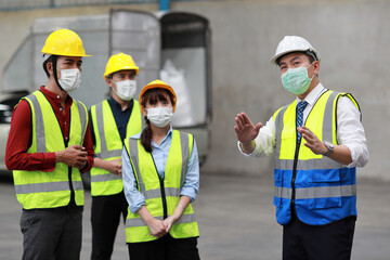 Group of technician engineer and businessman in protective uniform standing and discussing, researching, brainstorming and planning work together with protection mask at industry manufacturing factory