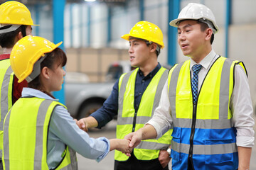 Group of asian technician engineer and businessman in protective uniform standing and discussing, researching, brainstorming and planning work together with hardhat at industry manufacturing factory