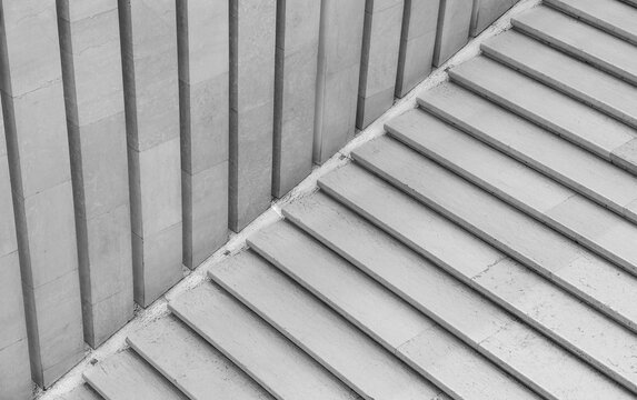 Geometric abstraction created by straight and diagonal lines of marble steps and panels. Black and white photo