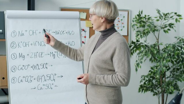 Portrait of confident lady teaching Chemistry in online school during covid-19 pandemic. Modern education and home schooling concept.