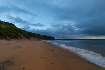 Stormy and cloudy view on an empty beach.