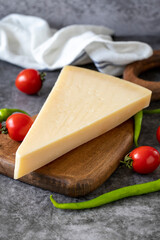 Parmesan cheese. Italian parmesan cheese on a wooden serving platter. close up