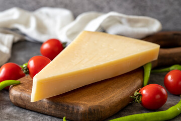 Parmesan cheese. Italian parmesan cheese on a wooden serving platter. close up