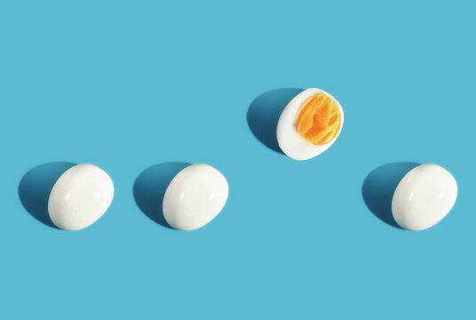 Difference boiled eggs on blue background. Think different concept and business success idea