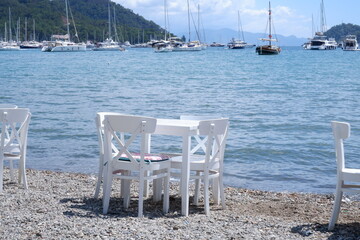 white table and chairs , summer vacation concept. Seaside front view. Selection focus table and chairs.