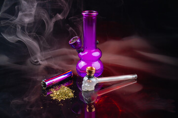 Glass bong with pipe and a lot of thick white smoke. Accessories of mj weed.