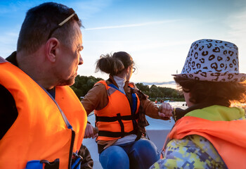 Friendly caucasian family floating on kayak with paddles. Concept of family rest, leisure and...