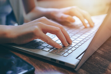 hands typing on keyboard,using laptop for seraching data on internet
