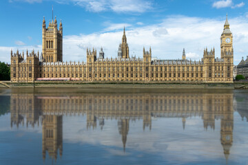 Fototapeta na wymiar Houses of the UK parliament in Westminster palace, water reflections in the Thames river, London