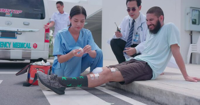 Emergency medical services Staff transporting an unconscious man to an ambulance on a stretcher