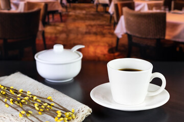 international coffee day, traditional colombian drink, mug of coffee and sugar with flowers on a restaurant table