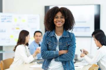 African American office woman Standing with his arms crossed and smiling at the camera in the office