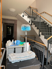 Room maintenance equipment in the interior of the staircase of a residential house. Cleaning supplies and equipment.