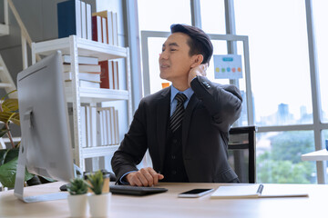 Businessman, Asian male company worker who sits at the office for a long time. Having neck and back pain back pain neck pain or office syndrome