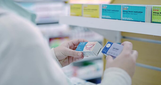 Pharmacist reading medicine in pharmacy, medical choice of healthcare pills in hands. Woman search pharma brand, pharmaceutical drugs packaging in store and wellness coldsore product on shop shelf