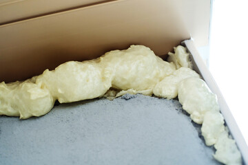 Insulation of the window sill or openings with mounting foam. Close-up