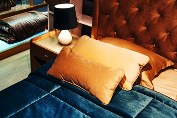 A fragment of a double bed with terry pillows and a blue bedspread. Close-up