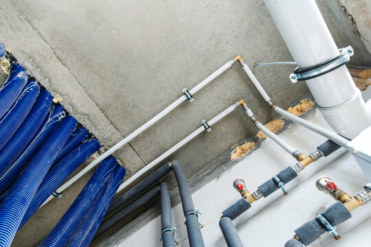 Pipes Of The Heating System Of A Private House In The Basement. Fragment Of A Boiler Room With Thermal Insulation And Protective Corrugation. Design And Installation Of Pipelines. Bottom Up View