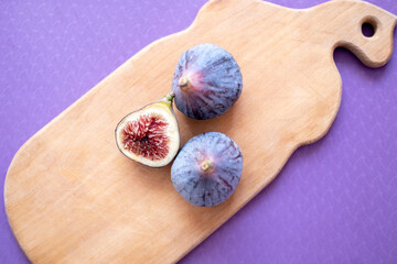 figs on a wooden background. half a fig. Healthy food, useful product. Autumn, harvest