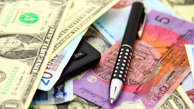 Calculator, pencil, money; American, Australian Dollars. Finance. Concept.