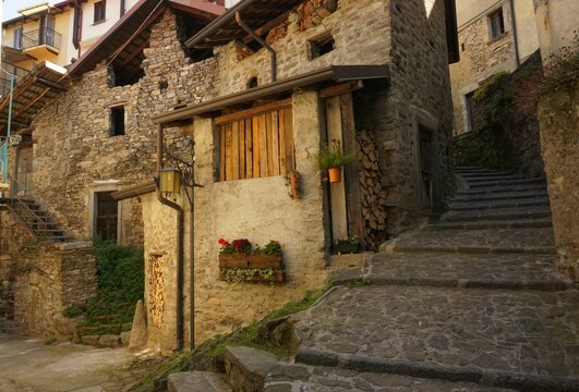 View of a glimpse of a small square among the alleys of the historic center of the ancient village of Careno,early in the morning . Lake Como, Italy.