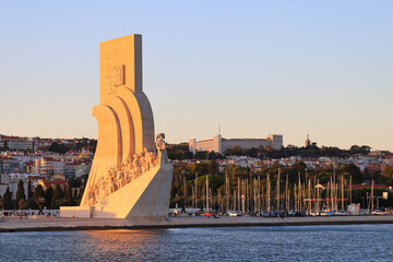 Sunset in Belém, Lisbon, the capital of Portugal. Padrão dos Descobrimentos, Monument to the Discoveries as seen from Tagus river.  - obrazy, fototapety, plakaty