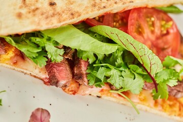 Pita bread filled with meat, vegetables and herbs. Breakfast or lunch. A dish from the chef for serving in a restaurant.
