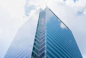 Fototapeta na wymiar Glass wall architecture building reflection cloud and sky background.concept for modern office