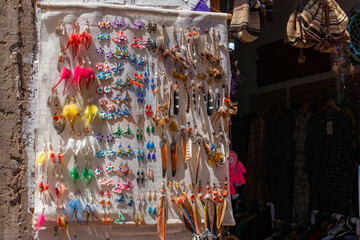 Typical store and sale of colorful handmade earrings in Pisac, Peru. 