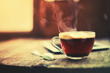 cup of hot coffee with tablet over rustic wooden table 