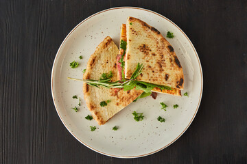 Sandwich with meat, herbs and spices. Breakfast or lunch. A dish from the chef for serving in a restaurant.