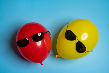 Red and yellow balloons with sunglasses