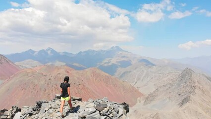 Close up aerial view Inspired caucasian hiker woman stand on top mountain enjoy panorama outdoors determined to reach personal goals concept. active lifestyle concept
