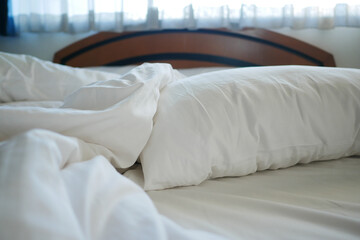 Fototapeta na wymiar messy white bed in early morning 