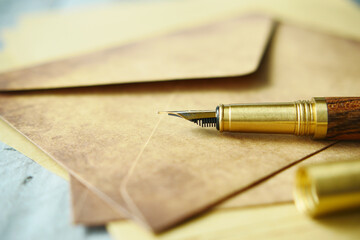 envelope , empty paper and fountain pen on table 
