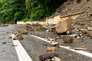 Scattered stones on the road. Rockfall. Rockfall on the road. Large rocks of rock fell on the...