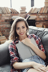 Comfortable and Cozy: Blonde Girl Posing in Various Relaxing Positions at Home, Reading and Working on Laptop