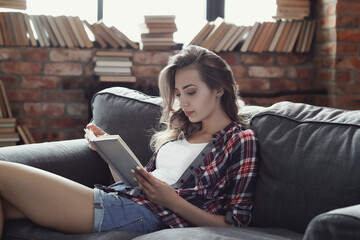 Comfortable and Cozy: Blonde Girl Posing in Various Relaxing Positions at Home, Reading and Working on Laptop
