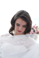 This stunning stock photo captures the beauty and elegance of a bride-to-be as she models a variety of wedding dresses in different poses within the cozy and intimate setting of her own home