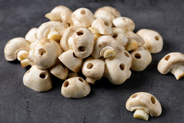 A bunch of raw champignon mushrooms in the form of skulls. Edible Halloween Concept