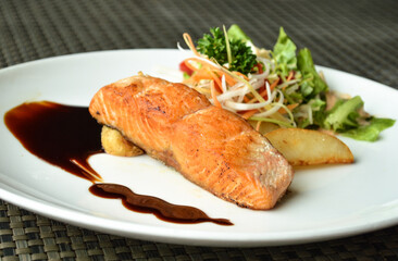 Pan fried salmon with teriyaki sauce on close-up view