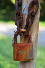 The old key was locked to a rusty chain attached to an iron post