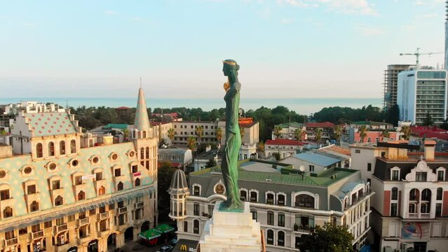Batumi, Georgia - 8th august, 2022: aerial circular view around Medea statue in europe square in popular tourist destination Batumi in summer.