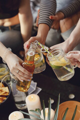 Get the party started with this fun and vibrant stock photo of a group of people enjoying food and drinks in the kitchen