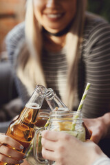 Get the party started with this fun and vibrant stock photo of a group of people enjoying food and drinks in the kitchen