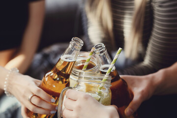 Get the party started with this fun and vibrant stock photo of a group of people enjoying food and drinks in the kitchen