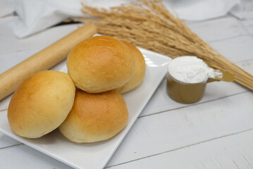 Fresh fragrant bread and bun on the table with copy space. Food concept