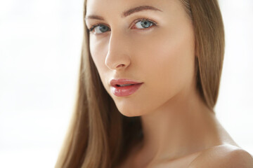 Fototapeta premium This captivating stock photo captures the beauty and creativity of a blonde model as she strikes playful and whimsical poses, putting her hands in various forms while capturing the perfect shot