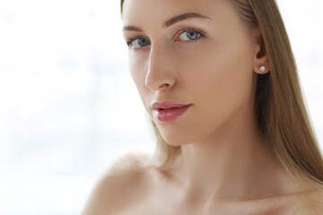 This captivating stock photo captures the beauty and creativity of a blonde model as she strikes playful and whimsical poses, putting her hands in various forms while capturing the perfect shot