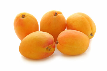 Several big flat ripe apricots isolated on white